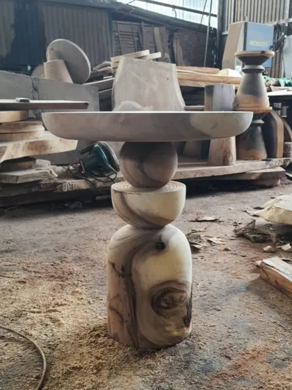 A sculptural side table with a stacked, spherical base.