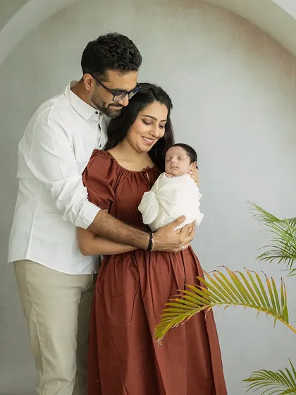 A full family portrait with a newborn, styled with earthy tones and natural elements. This shot shows how we can create a warm, organic feel even in a studio setting.