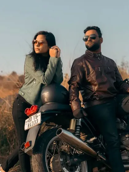 The epitome of cool. Leaning against their motorcycle with the open country behind them, this couple exudes confidence and a shared love for adventure. This is a modern, edgy take on a pre-wedding portrait.