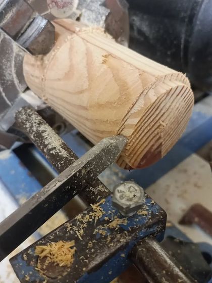 Getting started on the wood lathe. Here, I'm using a spindle gouge to turn a square block of pine into a cylinder, the first step in making a lidded box.