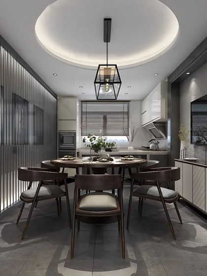 A sophisticated dining area set within a narrow space next to the kitchen. The slatted wood wall with integrated lighting adds depth and warmth, while the round table improves flow.