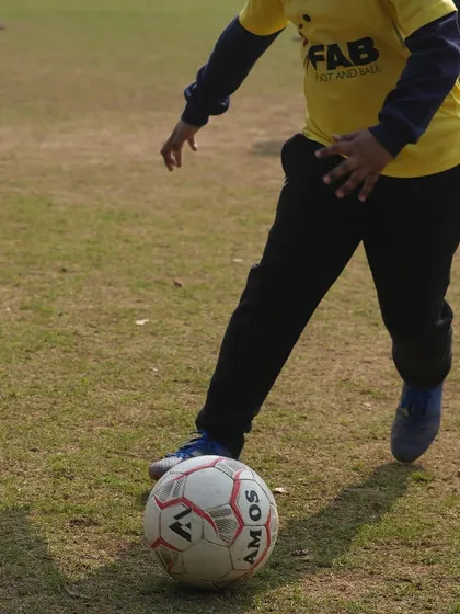 A close-up of a player's foot on the ball. This represents our focus on the fundamentals and mastering the basics of ball control.