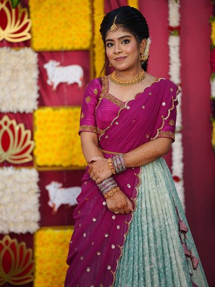 Nothing makes me happier than dressing sisters for their special moments. I designed these matching turquoise and purple Langa Voni outfits for a half saree function, ensuring they both looked coordinated yet unique.