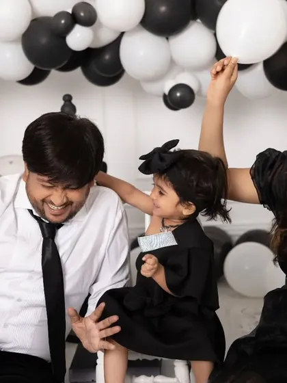 Family sessions are always full of fun. This playful moment from a cake smash shows the genuine laughter and connection we aim to capture when you bring the whole family to the studio.