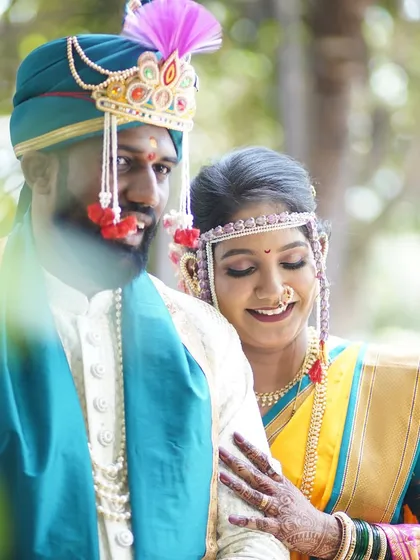 A beautiful candid of the couple, lost in their own world. The bride's makeup is soft and romantic, perfect for capturing these unscripted moments of love.