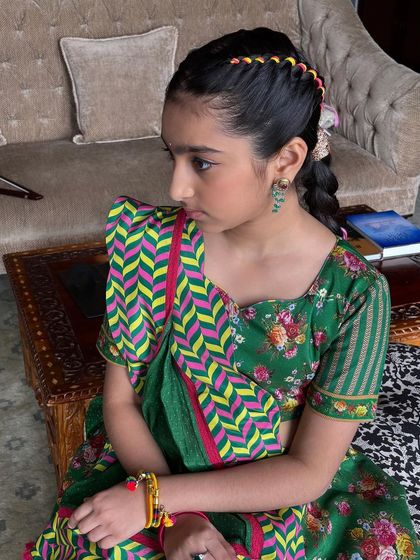 Another shot of the young client, looking poised and pretty with her festive hairstyle.