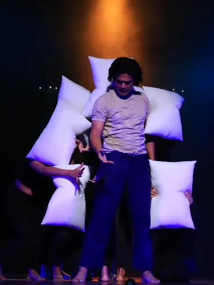 A scene from our contemporary piece, "ME & MY PILLOW," performed at the Taal Tarang Dance Festival. Here, dancers use pillows as props to explore themes of comfort, conflict, and connection, highlighted by dynamic stage lighting.