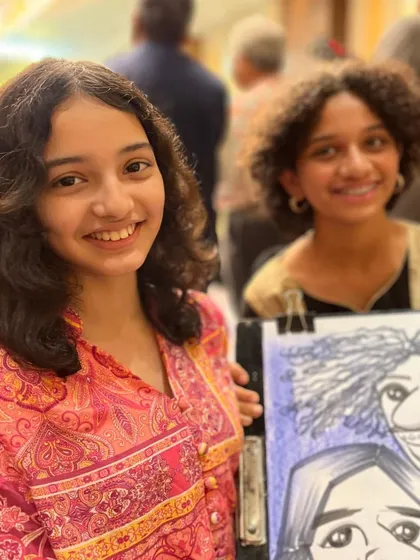 Two young girls with their group caricature, capturing their friendship and fun personalities.