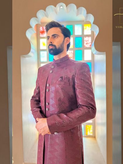 A side profile of the maroon sherwani, showcasing its sleek fit and elegant design.