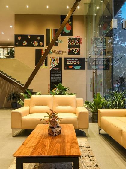 A comprehensive look at a conventional commercial space, highlighting the double-height reception, glass-walled mezzanine, and various product display areas designed for a modern business.