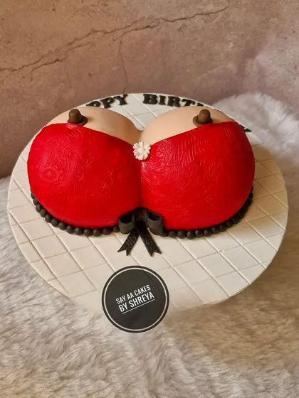 This is another version of my popular red bra cake, a fun and cheeky design for adult birthdays. It's all about celebrating with a wink and a smile, and of course, a delicious slice of cake.