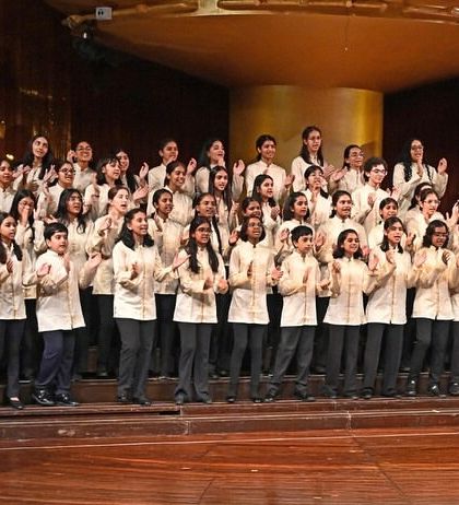 The choir takes a well-deserved bow, their faces beaming with pride after a successful performance. The applause is a wonderful reward for their hard work.