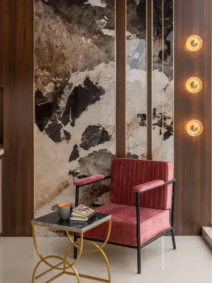 I believe the little details are what make a design truly special. For this cozy reading corner, I used a large format tile with a beautiful marble pattern as a feature wall. Paired with a comfortable chair and warm lighting, it has become one of the most loved spots in the house.