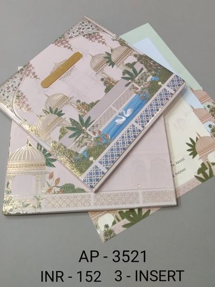 A pastel pink invitation with a serene palace and water scene, highlighted with gold foil. This card comes with three inserts and is perfect for a dreamy, romantic wedding theme.