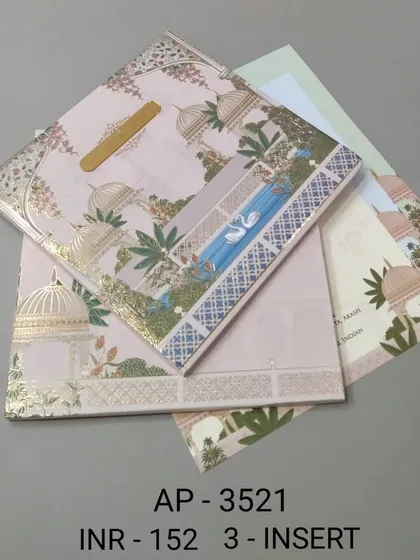 A pastel pink invitation with a serene palace and water scene, highlighted with gold foil. This card comes with three inserts and is perfect for a dreamy, romantic wedding theme.