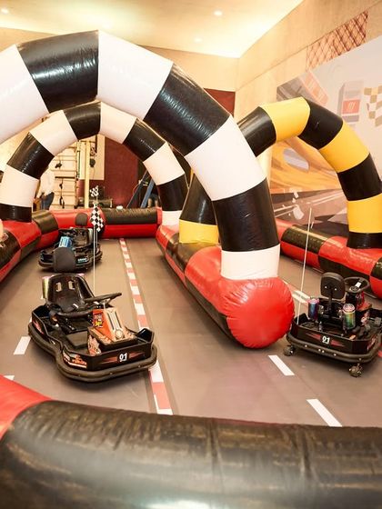 I installed a complete, inflatable go-kart track inside the venue, allowing the kids to safely race and live out their Formula 1 dreams.