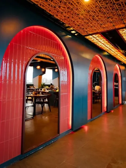 We used a bold color palette and repeating architectural forms to create a dramatic entryway at Bramble. The glowing red tiled arches guide guests through the space, setting a vibrant and energetic tone for the bar and kitchen.