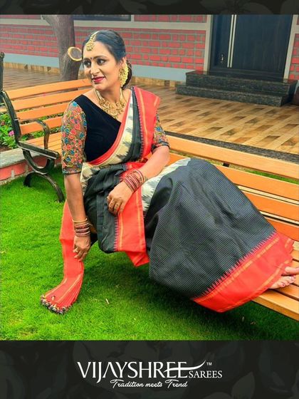 Deepa Sudish looking elegant in a black and white Kanchi cotton saree with a vibrant red border.