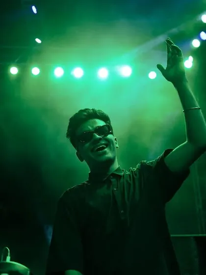 Waving to the crowd under the green lights. It was a night of great music and unforgettable memories.