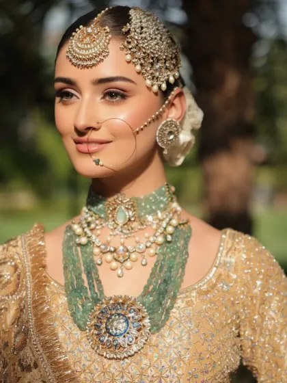 The elegance of a traditional bridal look is timeless. Here, the combination of a gold lehenga, a neat floral bun, and statement jewelry creates a vision of pure grace.