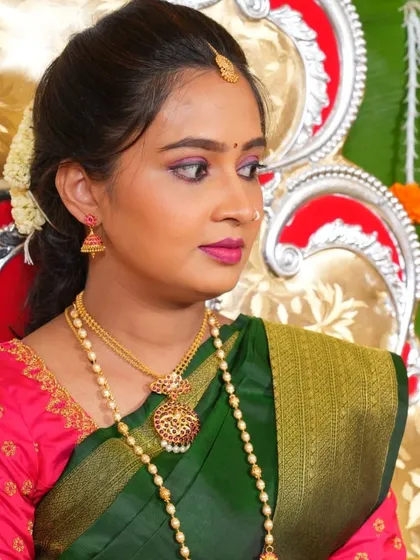 A close-up of the baby shower makeup, showing the soft pink eyeshadow and matching lip color that complements the green saree and pink blouse.
