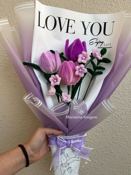 Introducing our new Korean-style pipe cleaner flower art. This bouquet features soft, fuzzy tulips in shades of purple and pink, wrapped beautifully for gifting.
