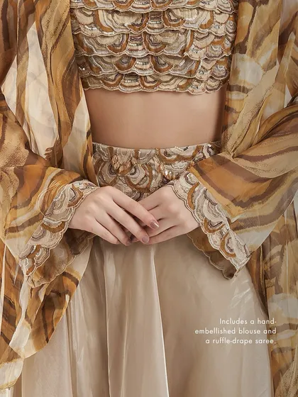 A detail shot of the Adoree Cape Set in a different colorway, focusing on the hand-embellished blouse and the ruffle-drape detail.