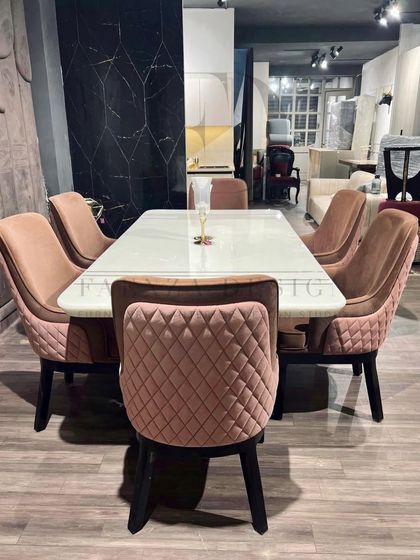 This dining set pairs a white onyx table with stunning chairs upholstered in a quilted dusty rose velvet. The combination of colors and textures creates a look that is both modern and romantic.