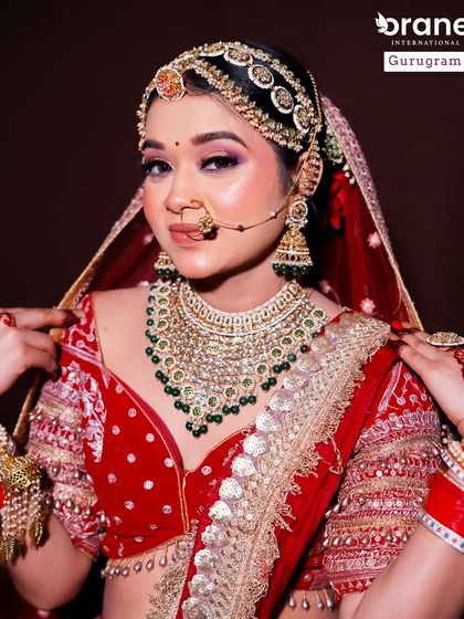 A beautiful portrait of a student's work on a traditional red bridal look. The focus on clean, defined eyes and flawless skin is a testament to the quality of training I provide.