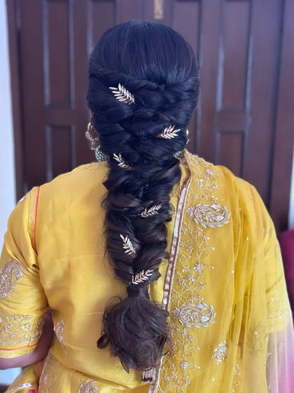 Unleash your inner queen with this regal braid, adorned with glistening golden leaves for a touch of royal elegance.