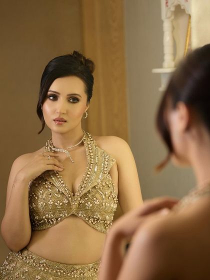 A client looking absolutely stunning with a romantic updo. The hair is gathered loosely at the back with soft tendrils left out to frame her face, creating a very feminine and sophisticated cocktail look.