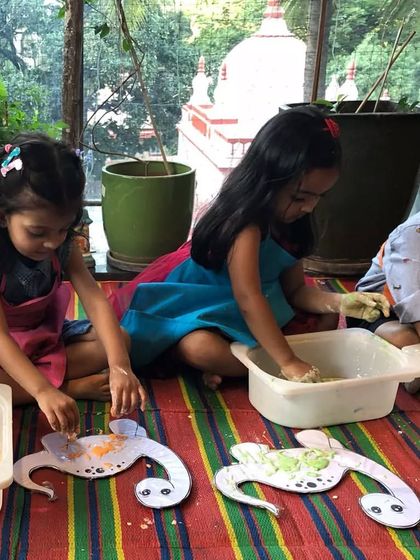 Birthday fun continues with more sensory play. The kids are now working with dough and creating turtle-themed crafts on their individual trays.