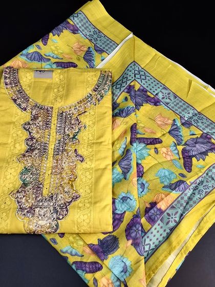 A bright yellow Mangalgiri cotton dress material with a beautiful embroidered neckline. The matching printed dupatta completes this cheerful and festive set.