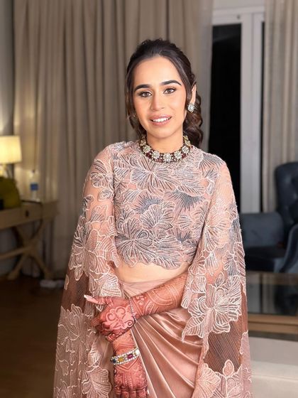 The bride's complete look for her cocktail party. The high ponytail is the perfect choice for her modern, elegant outfit.