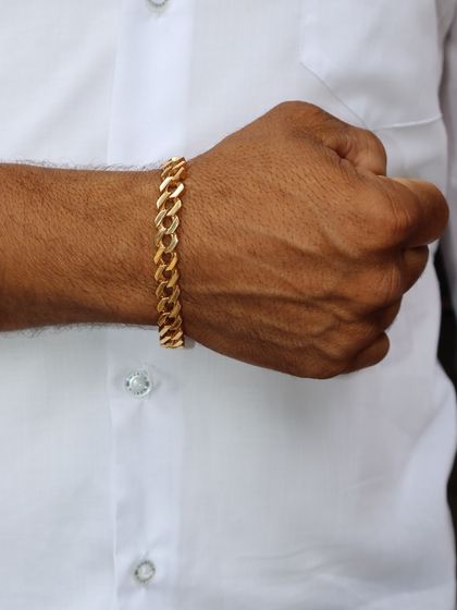 For a more classic look, this thick gold curb-link bracelet is a timeless gift that he can wear for years to come. It is a solid investment in style.