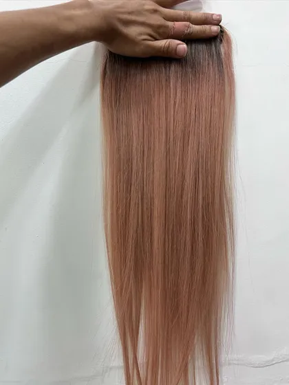 This swatch shows a blush pink with a shadow root. This technique helps the color blend more naturally as it grows out.