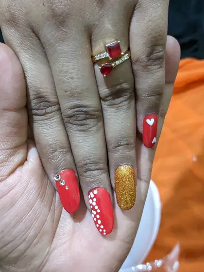 This set is all about fun and personality. I used a vibrant red gel polish and created custom art, including a gold glitter accent nail, tiny white hearts, delicate dot work, and a few rhinestones for extra glam.