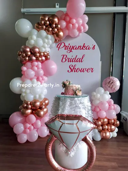 This is our classic bridal shower decoration, perfect for creating a feminine and celebratory atmosphere. The design includes a personalized arched backdrop, an organic balloon garland in pink, white, and rose gold, and a large diamond ring foil balloon for that perfect photo opportunity.