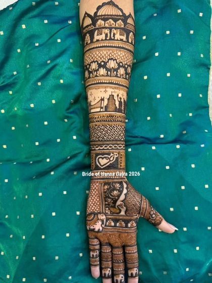 A journey wrapped around her arm. This full-arm design features layers of storytelling, from royal elephants and blooming lotuses to a cityscape representing the couple's journey.