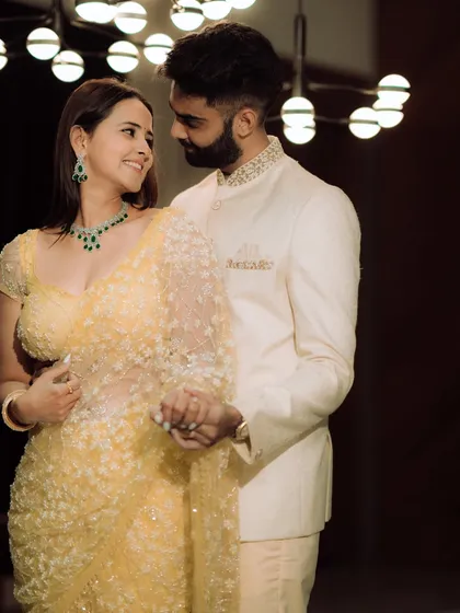 A moment of pure, unscripted laughter. The groom whispers something to his bride-to-be, and her resulting joy is beautifully captured, showcasing the genuine connection that makes for the best photographs.