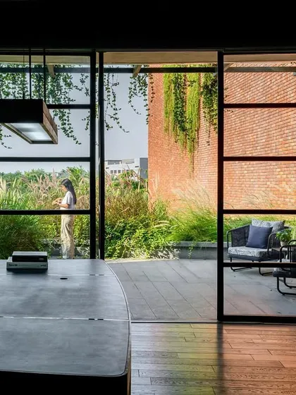 I love to blur the line between indoors and outdoors. This office at the Greenlab factory features floor to ceiling windows that open onto a private terrace, making the surrounding landscape an integral part of the workspace.