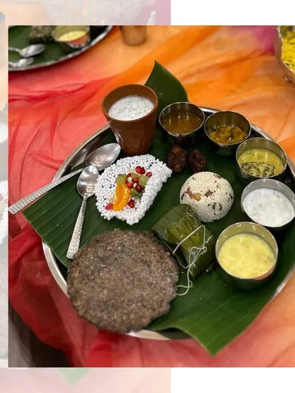 A close up of our authentic Navratri thali, served on a banana leaf. You can see the variety of dishes, including sabudana khichdi, fruit salad, curries, and a traditional flatbread.
