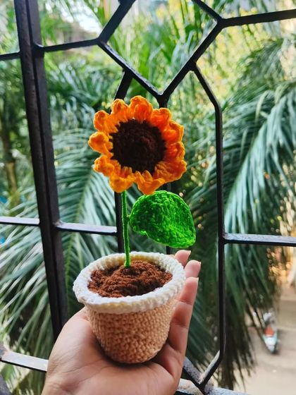 Holding my crochet sunflower pot. It fits perfectly in the palm of your hand and is such a cute and charming decorative item.