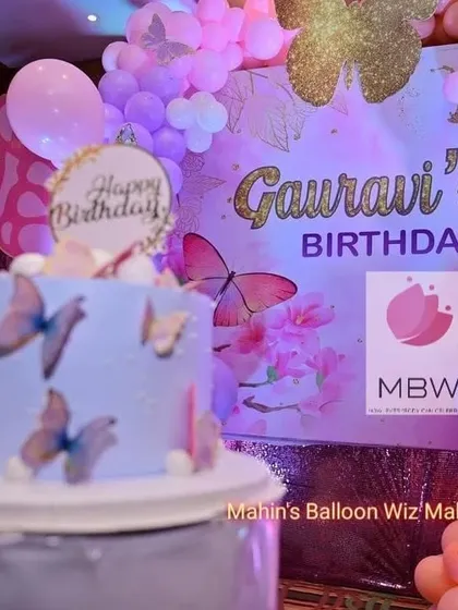 The birthday cake positioned in front of the personalized backdrop, showing how every element of the party is perfectly coordinated.