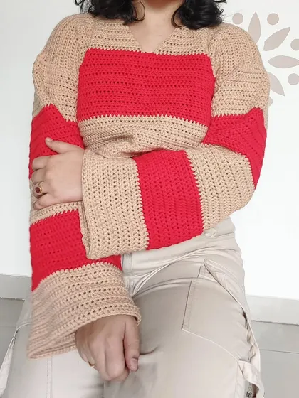 This is my Cotton Candy Sweater, featuring bold red and beige stripes and dramatic bell sleeves for a retro-inspired look.