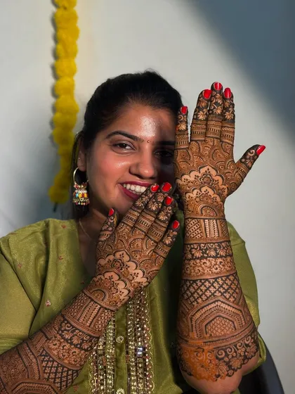 A lovely candid shot of my friend, her happiness radiating. Her hands are adorned with a beautiful, dense bridal design.