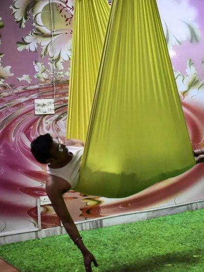 Fitness is all about being better than you used to be. This student is finding deep relaxation and a gentle stretch in the hammock, a key benefit of the practice.