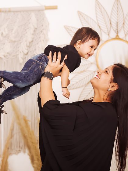A mother's loving gaze as she lifts her child high. These candid, interactive shots result in the most genuine smiles and create beautiful, emotion-filled family portraits.