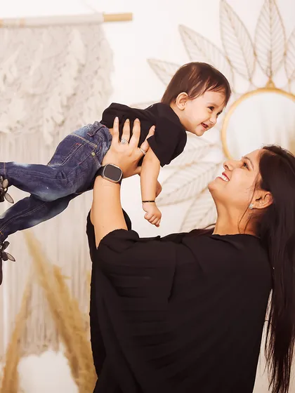 A mother's loving gaze as she lifts her child high. These candid, interactive shots result in the most genuine smiles and create beautiful, emotion-filled family portraits.