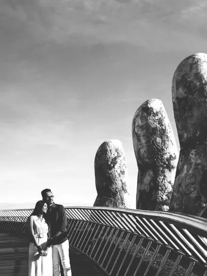 An epic, wide-angle shot of a couple on Vietnam’s iconic Golden Bridge. This image highlights our expertise in destination photography, capturing both the grandeur of the location and the couple's shared journey.
